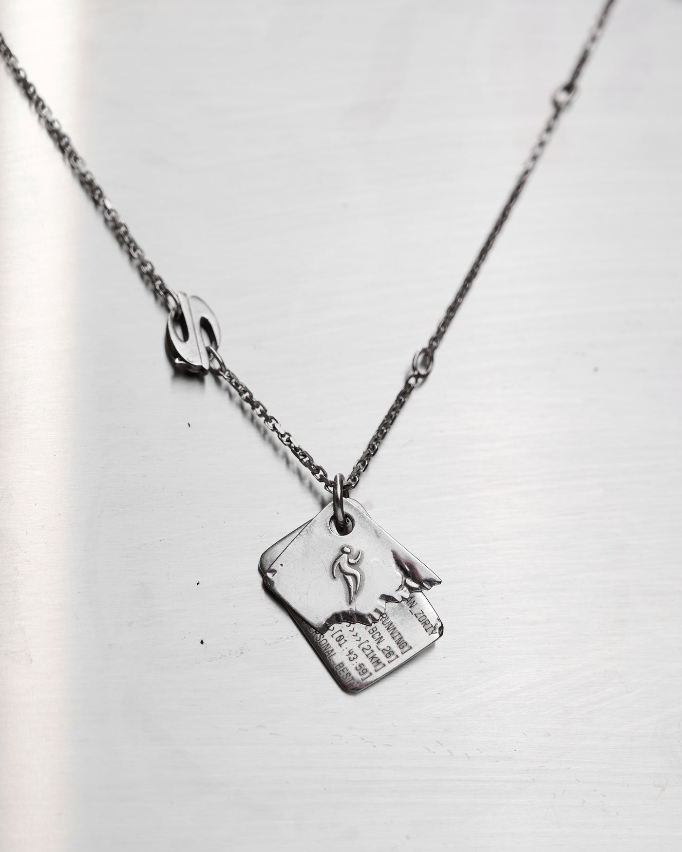 Finish Artifact VO1 sterling silver pendant and chain on a light background